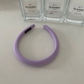 Detail of light purple fabric headband with a black handmade woven label inside - Purple