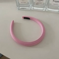 Detail of pink sponge headband with hand-made label and soft fabric texture surface - Pink