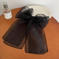 Elegant oversized black organza bow hair clip with long ribbons on a wooden surface - Large / Black