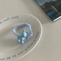 Detail of light blue mesh hair scrunchie with cute matte bear pendant on a ceramic dish - Blue Solid Rabbit