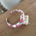 Detail of floral sponge headband showing the handmade label and soft pink flower print - Rose Red Large Flower