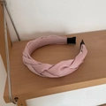 Macro view of braided pink satin headband showing high-volume twisted fabric texture - Pink