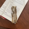 Close-up of a French wavy acetate hair claw clip with tortoise shell pattern on a book - Light Leopard Print (2#)