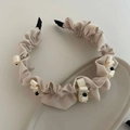 Elegant cream pleated headband with small bows and beaded accents on ceramic tray - Off White