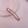 Vista detallada de una pinza para el cabello rosa transparente con mecanismo de resorte - Rojo Caramelo