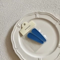 Close-up of two matte blue teardrop hair clips on a white ceramic tray in a stylish setting - Dark Blue Matte Hair Clips / Dark Blue
