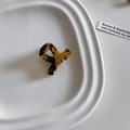 Detailed top view of a small tortoiseshell acetate hair claw on a white tray - Tortoiseshell (7#)