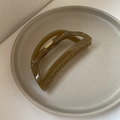 Detailed close-up of dark olive green minimalist shark hair clip on a ceramic plate - 3# Grass Green