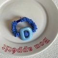 Blue scrunchie with letter D acrylic decoration on a white ceramic plate - Blue Scrunchie With Blue Letter
