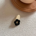 Close-up of cream and black floral hair clip on a textured white background - Black Flower (Creamy Clip)