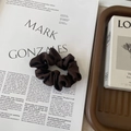Detail of dark brown silk satin hair scrunchie with soft pleats on a stylish flat lay - Small / Khaki