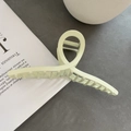 Elegante matgroene metalen haarklem met kruishol ontwerp op een stenen ondergrond - Grote Kruisstijl / Broken Wit