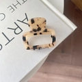 Macro shot of square acetate hair claw with cream tortoiseshell pattern and hollow design - Light Leopard