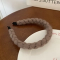 Detailed texture of thick knitted wool twist headband in camel brown color - Khaki