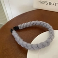 Classic gray knitted twisted headband with wool texture on wooden and ceramic background - Gray