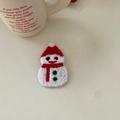 Close-up of a festive crochet snowman hair clip with red hat and green button detail - Christmas Snowman BB Clip (12#)