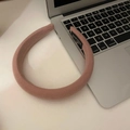 Pink fabric sponge headband with handmade label on top of a laptop keyboard - Creamy Pink