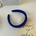 Detailed close-up of blue padded headband fabric with vertical texture and handmade label - Dark Blue