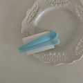 Set of two colorful macaron blue matte duckbill hair clips on a white ceramic plate - Blue