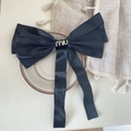 Large black satin bow hair clip with crystal miu lettering and long streamers - Black With Letter
