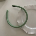 Detail of light green handmade sponge headband featuring a black woven label on inner side - Mint Green Stripe