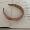 Morandi mauve wide padded headband in glossy satin fabric resting on a book - Glossy Korean Pink