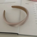 Macro detail of glossy champagne padded headband with smooth satin texture and non-slip lining - Glossy Beige Grey