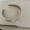 Detail of cream silk satin padded headband with premium texture on magazine background - Bright White