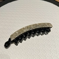 Detail of banana hair clip with elegant beige marble pattern and smooth black base - Beige Marble
