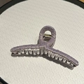 Close-up of lavender fabric texture and golden metal spring on large hair claw clip - Large / Purple