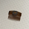 Macro detail of French vintage hair comb with silver square rhinestone buckle and brown teeth - Gray