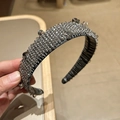Detailed macro view of handcrafted crystal beaded wide headband in shimmering charcoal grey - Gray