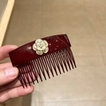 Macro detail of dark red camellia hair comb with pearl petals and rhinestone center - Burgundy Camellia