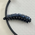 Detail of banana hair clip featuring sparkling blue and grey crystals on black base - Royal Blue Crystal