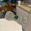 Elegant silver bow hair clip with sparkling zircons and square emerald green gemstone center - Green Stone Spring Clip