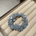 Elegant light blue cat eye stone hair ring with translucent beads on a beige jewelry tray - Light Blue