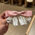 Dettaglio del fermaglio per capelli a fiocco in raso rosa e crema con bordi ondulati - Rosa