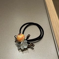 Detailed close-up of handmade hair tie with marble bead and faceted crystal elements - Black