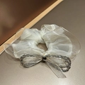 Close-up of white organza scrunchie with gold glitter edges and crystal beaded bow - Off White