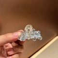 Detailed close-up of sparkling crystal hair claw clip with golden metal spring - Small / Light Blue
