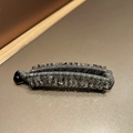 Macro detail of a grey fabric banana clip featuring sparkling crystal trim and a black buckle - Grey Crystal