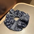 Detail of navy blue paisley print scrunchie with soft satin texture and neat stitching - Navy Blue Hair Scrunchie