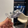 Close-up of elegant purple fabric hair claw clip with sparkling crystal beads - Blue