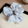Close-up of light blue scrunchie with embroidered camellia flowers and white pearls - Blue Scrunchie