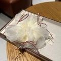 White organza scrunchie with pink ribbon bows on a wooden jewelry display tray - Off White