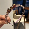 Close-up of purple satin headband with hand-stitched sparkling crystal embellishments - Purple