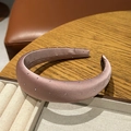 Detail of pink satin headband with silver rhinestones on a velvet display tray - Pink