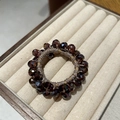 Deep brown faceted crystal bead hair tie elastic scrunchie shown on jewelry display tray - Purple
