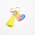 Close-up of resin heart keychain with golden rose sequins and bright yellow silk tassel - Multi Rose with Yellow Tassel