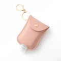 Pink PU leather hand sanitizer keychain holder with gold metal ring on white background - Light Pink